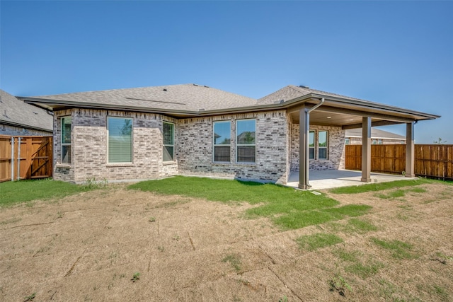 406 Eaton Dr, Justin, TX 76247 - back of property with a lawn, a fenced backyard, a patio, brick siding, and roof with shingles