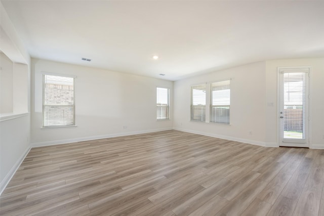 406 Eaton Dr, Justin, TX 76247 - unfurnished living room featuring baseboards, visible vents, and light wood-style floors