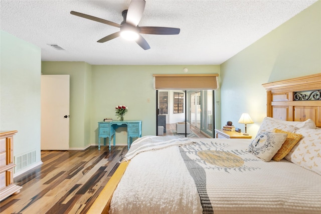 bedroom featuring a textured ceiling, wood finished floors, and visible vents