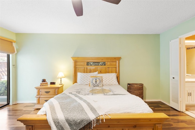 bedroom with baseboards, a textured ceiling, dark wood-style flooring, and a ceiling fan