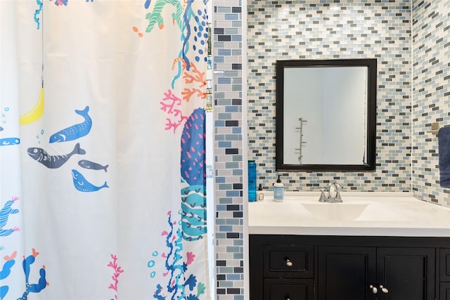 bathroom featuring vanity and decorative backsplash