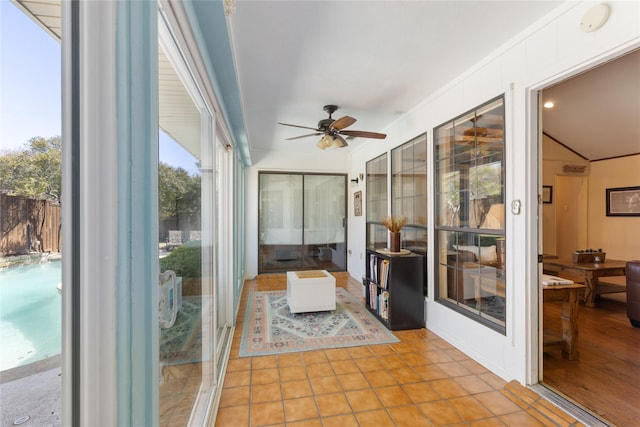 sunroom featuring tile patterned floors and ornamental molding