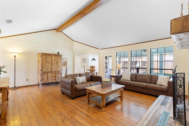 living area with vaulted ceiling with beams, light wood-type flooring, and visible vents