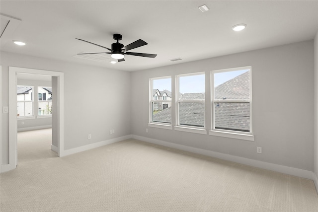 empty room featuring attic access, baseboards, light colored carpet, ceiling fan, and recessed lighting
