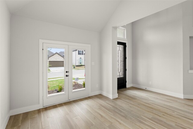 entryway featuring french doors, plenty of natural light, baseboards, and light wood-type flooring