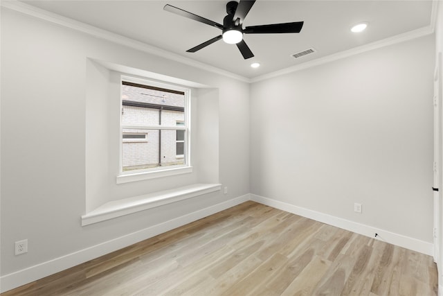 empty room with baseboards, crown molding, light wood-style flooring, and a ceiling fan