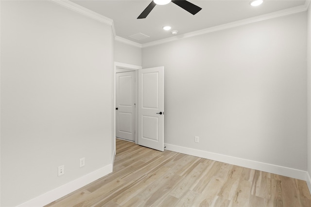 empty room with light wood-style flooring, crown molding, baseboards, and ceiling fan