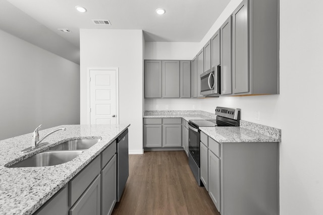 10637 Bleat St, Fort Worth, TX 76036 - kitchen with stainless steel appliances, gray cabinets, a sink, light stone countertops, and dark wood-style floors