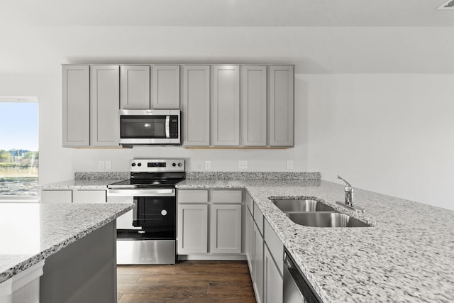 5056 Cervinae Rd, Fort Worth, TX 76036 - kitchen featuring appliances with stainless steel finishes, a sink, gray cabinetry, and light stone countertops