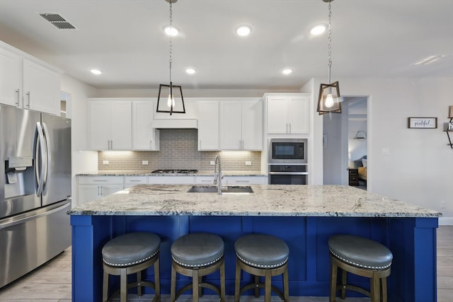 4529 Tolkien Ave, Celina, TX 76227 - kitchen with appliances with stainless steel finishes, a sink, backsplash, white cabinets, and recessed lighting