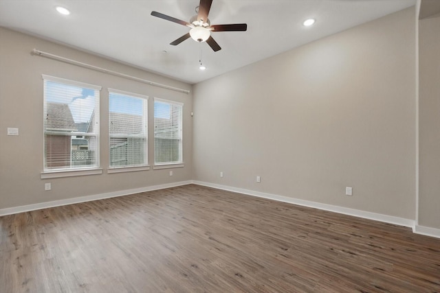 spare room featuring baseboards, a ceiling fan, wood finished floors, and recessed lighting