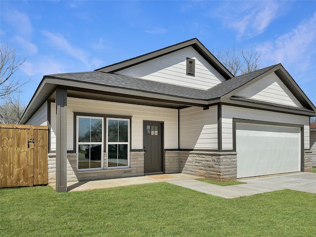 view of front of house with a front yard, an attached garage, and roof with shingles