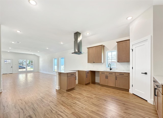 kitchen featuring open floor plan, recessed lighting, a sink, light wood-style flooring, and ventilation hood