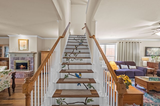 4167 Prairie Meadow Ct, Fort Worth, TX 76244 - stairs with a ceiling fan, a fireplace, ornamental molding, and wood finished floors