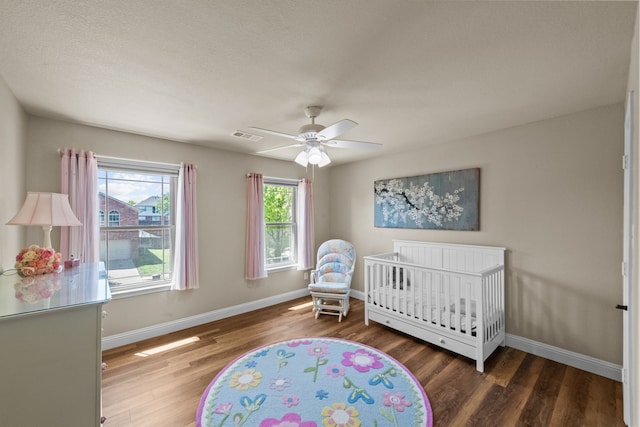 4167 Prairie Meadow Ct, Fort Worth, TX 76244 - bedroom featuring wood finished floors, baseboards, a ceiling fan, and a crib