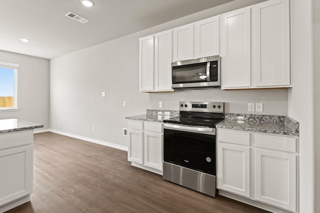 10569 Taruca Dr, Fort Worth, TX 76036 - kitchen featuring appliances with stainless steel finishes, dark wood finished floors, white cabinets, baseboards, and light stone counters