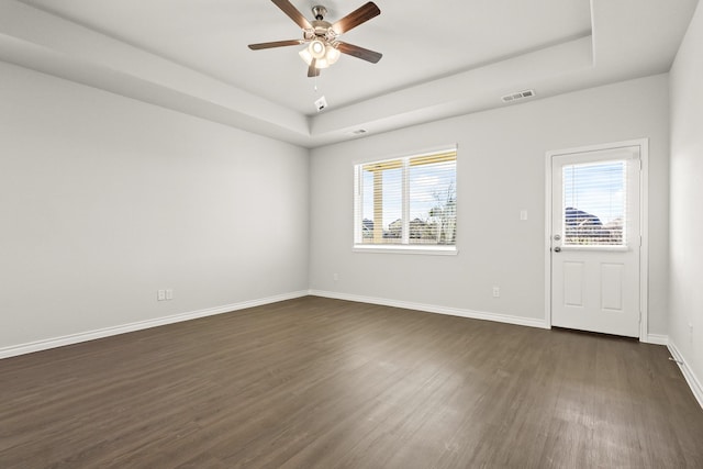 5025 Wellborn Rd, Fort Worth, TX 76036 - spare room featuring dark wood finished floors, a ceiling fan, baseboards, and a tray ceiling