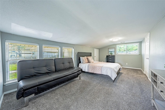 carpeted bedroom with baseboards, lofted ceiling, and a textured ceiling