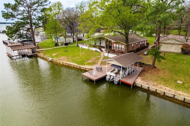 view of dock with boat lift, a water view, and a lawn