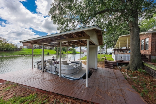 dock area with boat lift and a water view
