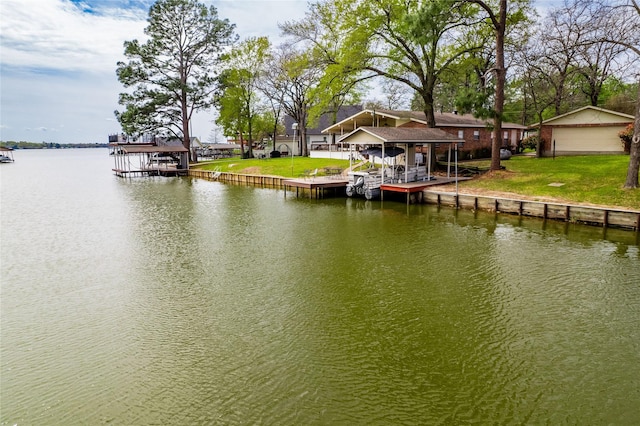 dock area with a lawn and a water view