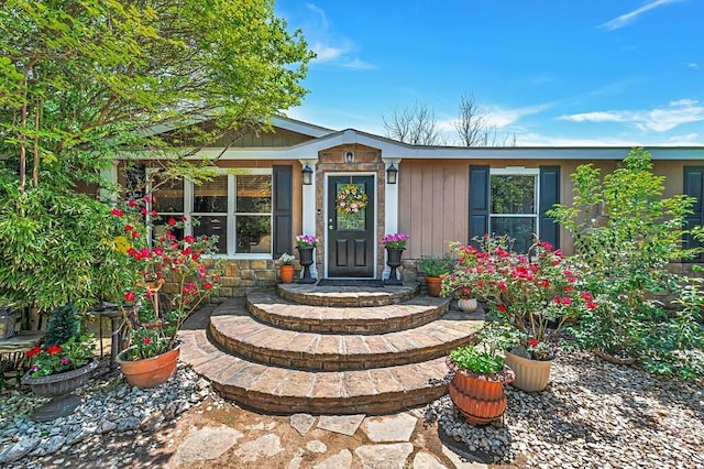 property entrance featuring stone siding
