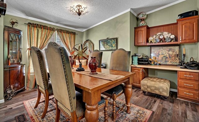 dining area featuring dark wood-type flooring, built in desk, a textured ceiling, and crown molding