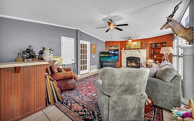 tiled living area featuring crown molding, a ceiling fan, plenty of natural light, and a textured ceiling
