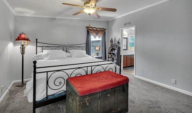 carpeted bedroom with visible vents, baseboards, a sink, ornamental molding, and a textured ceiling