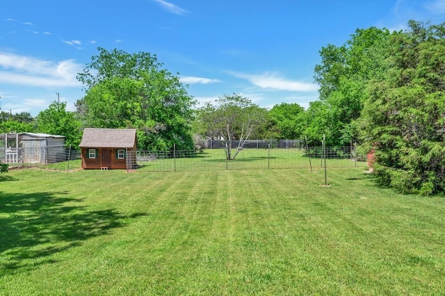 view of yard with fence and an outdoor structure