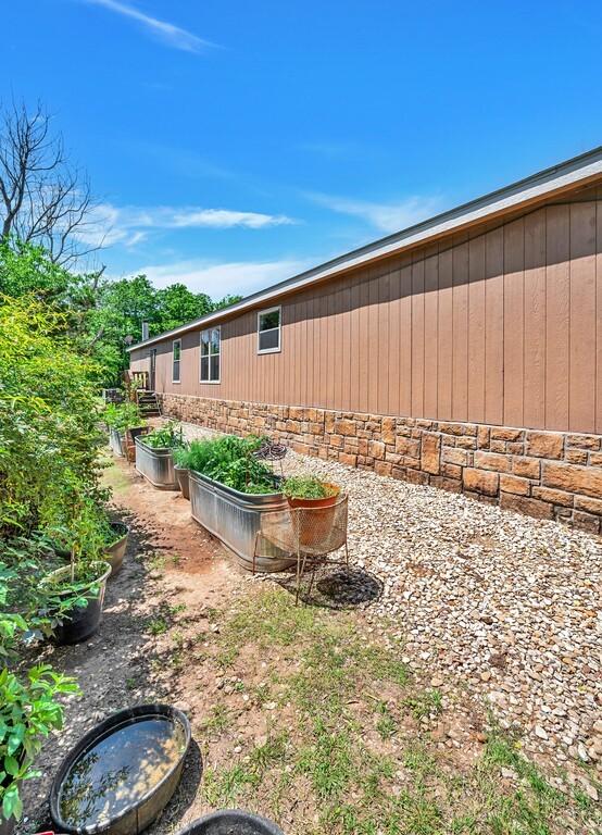 view of home's exterior with a garden