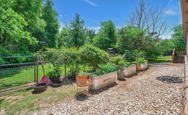 view of yard with a garden and fence