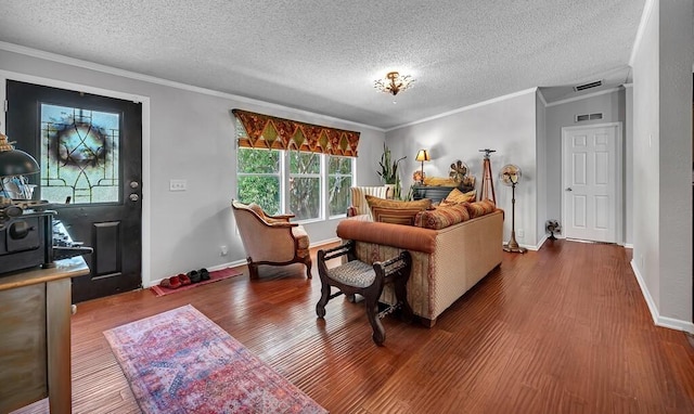 living room with ornamental molding, wood finished floors, and visible vents