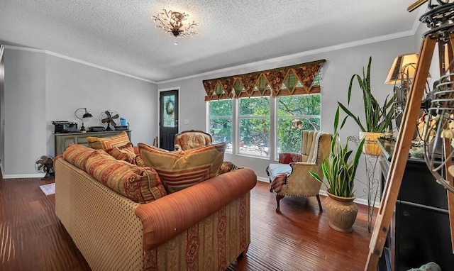 living area with ornamental molding, baseboards, wood finished floors, and a textured ceiling