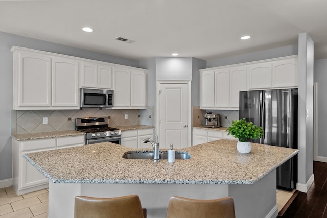 11317 Denet Creek Ln, Fort Worth, TX 76108 - kitchen with a sink, white cabinets, baseboards, appliances with stainless steel finishes, and visible vents