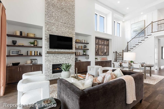 2352 Flora Dr, Mclendon Chisholm, TX 75032 - living area featuring a high ceiling, dark wood finished floors, stairway, and a fireplace