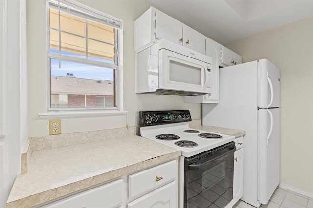 8511 Westover Ct Unit 217, Granbury, TX 76049 - kitchen with white appliances, white cabinetry, light countertops, and light tile patterned flooring