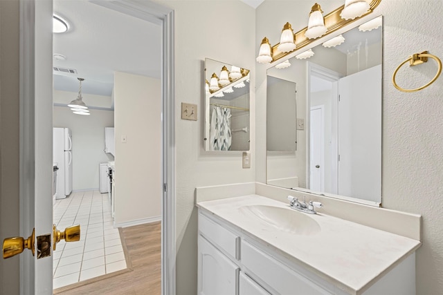 8511 Westover Ct Unit 217, Granbury, TX 76049 - bathroom featuring vanity and wood finished floors