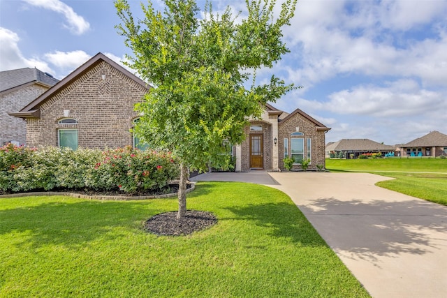 3721 Homeplace Dr, Celina, TX 75009 - view of front facade with brick siding, a front yard, and driveway