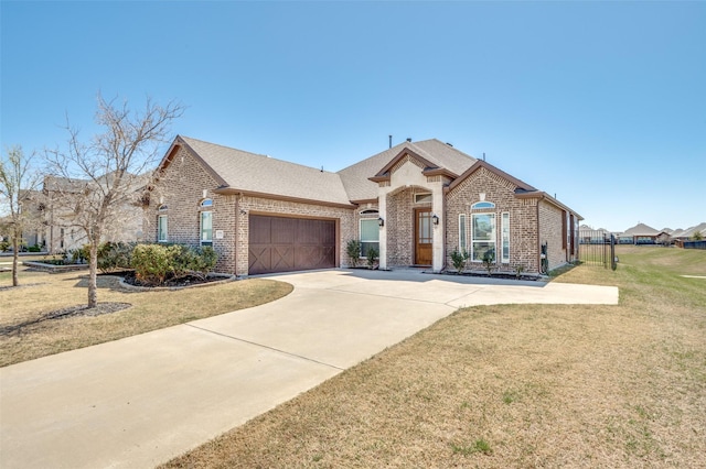 3721 Homeplace Dr, Celina, TX 75009 - french country inspired facade featuring brick siding, a garage, driveway, and a shingled roof