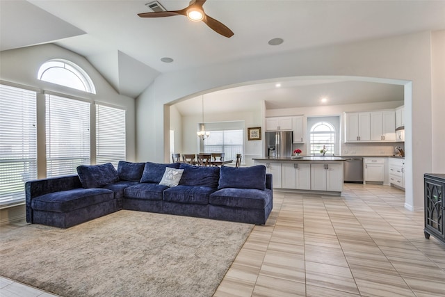 3721 Homeplace Dr, Celina, TX 75009 - living area featuring arched walkways, a ceiling fan, light tile patterned floors, lofted ceiling, and a chandelier