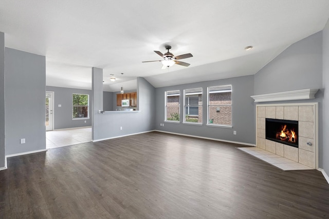9304 Warren Dr, Mckinney, TX 75071 - unfurnished living room with a fireplace, wood finished floors, vaulted ceiling, and ceiling fan