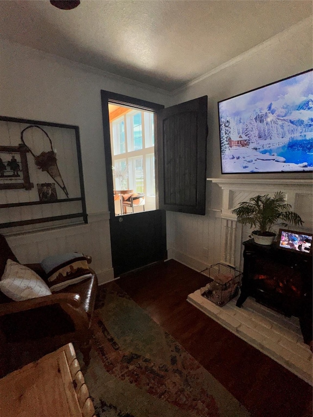 3163 Ranch Rd, Athens, TX 75751 - living area with wood finished floors, a wainscoted wall, and ornamental molding