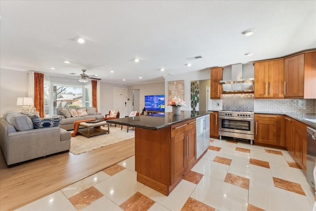 kitchen featuring appliances with stainless steel finishes, wall chimney exhaust hood, open floor plan, brown cabinetry, and recessed lighting
