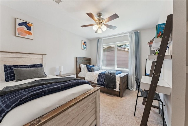 bedroom with light colored carpet and a ceiling fan