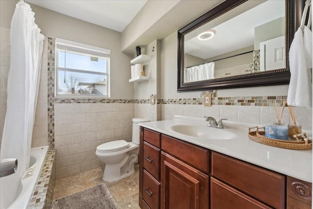 full bathroom featuring tile walls, toilet, vanity, and tiled shower / bath
