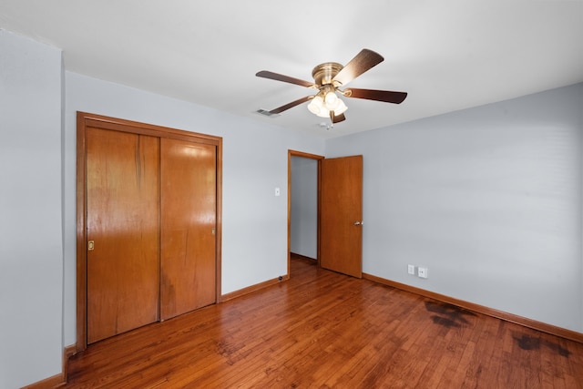 1330 S Pecan St, Arlington, TX 76010 - unfurnished bedroom with visible vents, a closet, baseboards, a ceiling fan, and hardwood / wood-style flooring