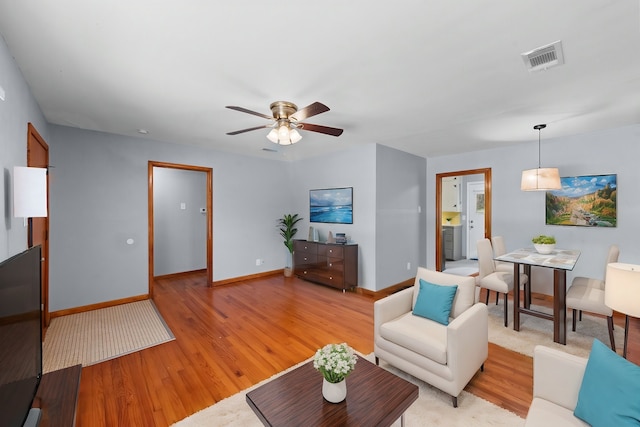 1330 S Pecan St, Arlington, TX 76010 - living room featuring light wood finished floors, visible vents, baseboards, and ceiling fan