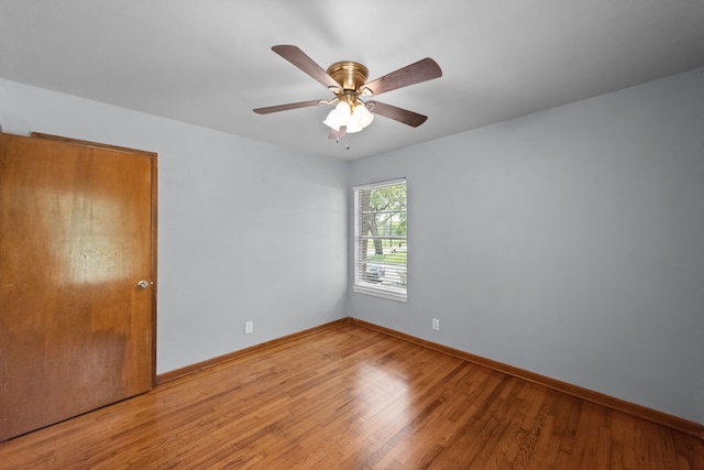 1330 S Pecan St, Arlington, TX 76010 - empty room with wood finished floors, ceiling fan, and baseboards