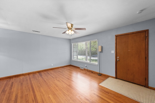 1330 S Pecan St, Arlington, TX 76010 - unfurnished room with visible vents, baseboards, wood finished floors, and ceiling fan